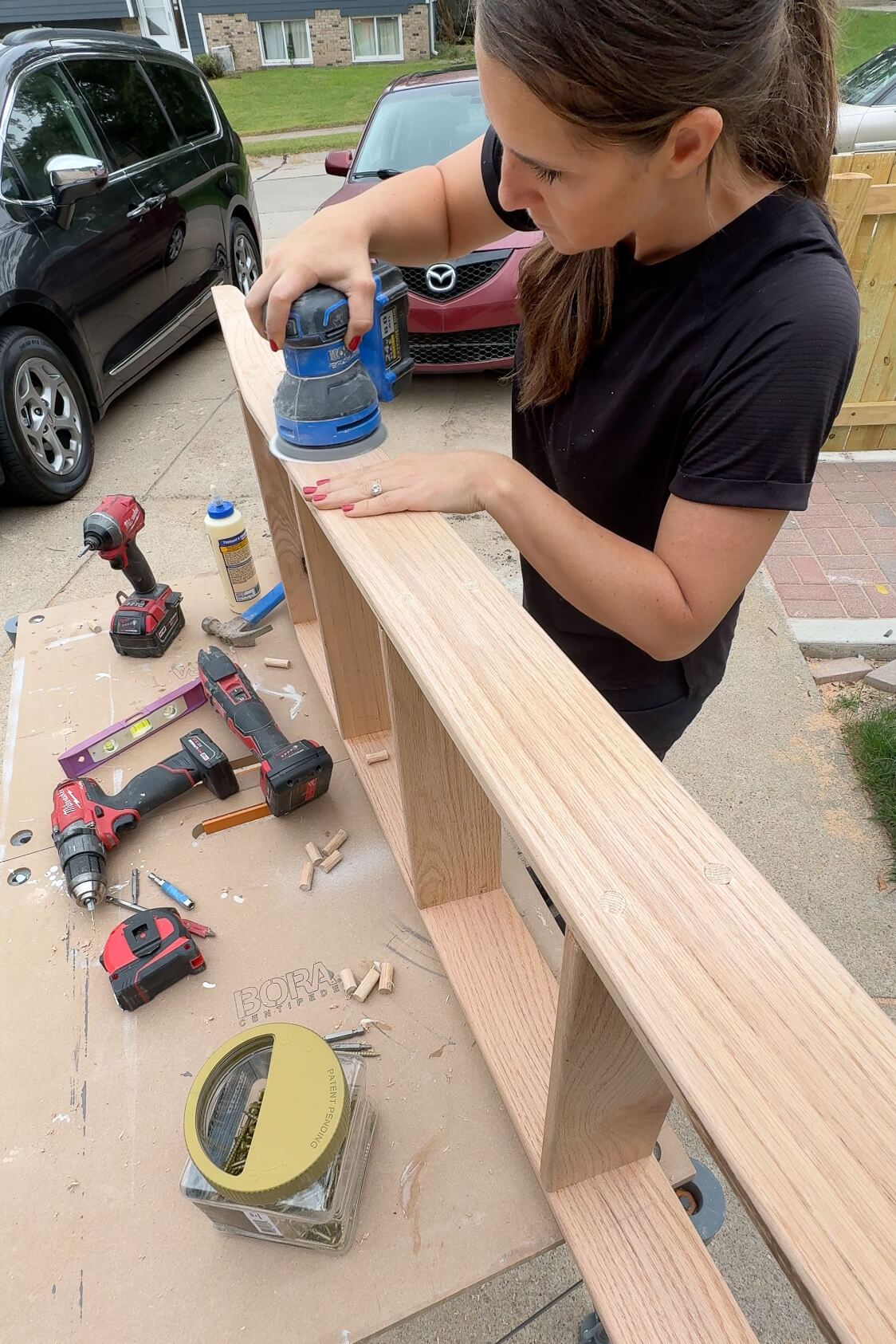 Adding dowels to cover screw holes on a ladder for DIY bunk beds.